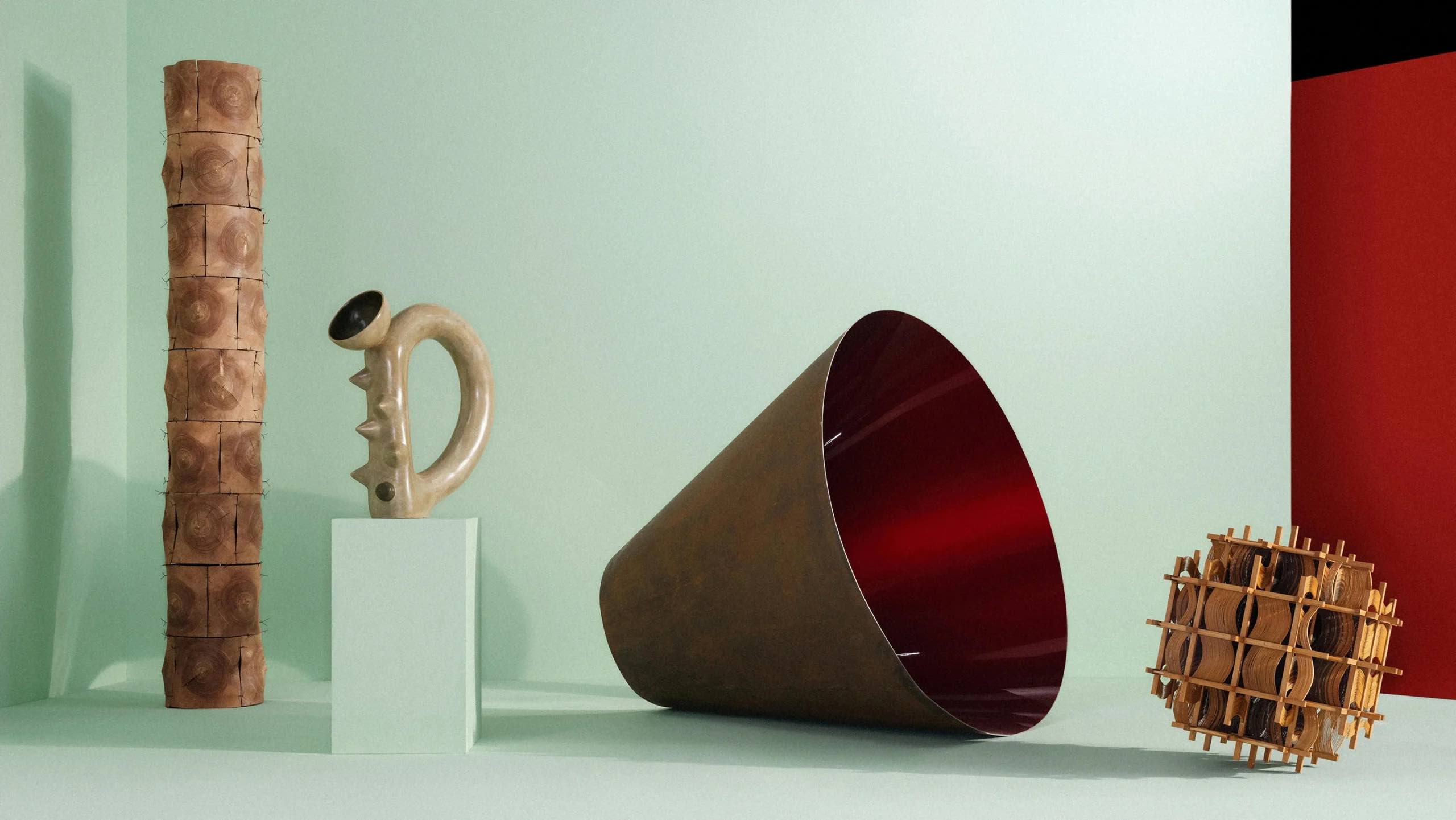 Four objects in a gallery setting.